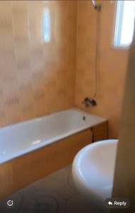 a bathroom with a bath tub and a sink at BUSUMBALA RESIDENTs in Busumbala +17 photos
