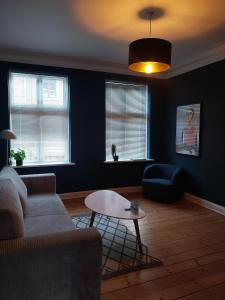 a living room with a couch and a table at Danmarksgade Green Suites in Aalborg