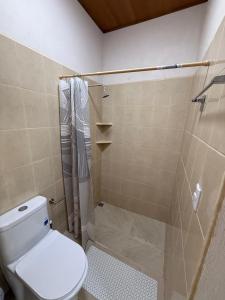 a bathroom with a toilet and a shower at Hostal Casa Hope in Rivas +3 photos