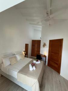 a bedroom with a large bed with two pillows on it at Logement chic au style tropical contemporain in Îlet à Christophe
