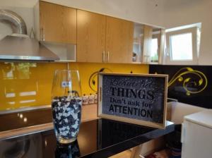 a sign that says things dont ask for attention in a kitchen at Pandora Apartments Sarajevo in Sarajevo