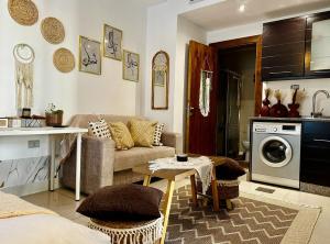 a living room with a couch and a table at Boho studio in Amman