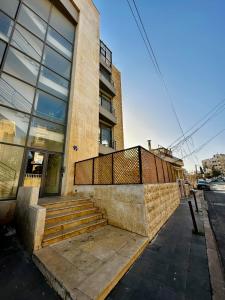 a building with stairs in front of a building at Boho studio in Amman