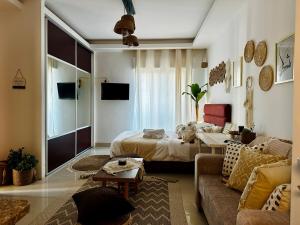 a living room with a bed and a couch at Boho studio in Amman