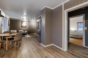 a living room with a dining table and a bedroom at Fauske Central Apartment - Cozy & Walkable in Fauske +3 photos