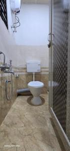 a bathroom with a toilet and a shower at Lavish Abode black & white in Guwahati +15 photos