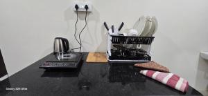 a black counter top with a container of kitchen utensils at Lavish Abode black & white in Guwahati