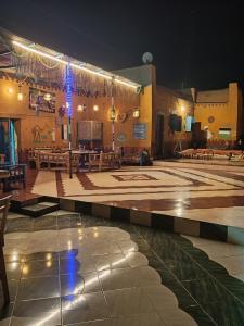 a large amphitheater with a stage with tables and benches at Miral Nubian House in Aswan