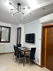 a dining room with a table and chairs and a television at Casa Ponte in Ponte San Giovanni