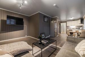a living room with a couch and a table at Fauske Central Apartment - Cozy & Walkable in Fauske