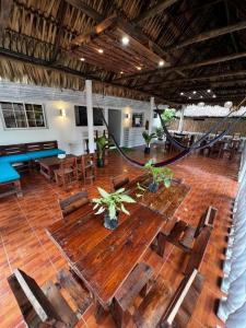 a large wooden table and chairs in a room at Backpackers Hostel in El Paredón Buena Vista