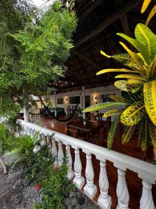 a porch of a house with a white railing at Backpackers Hostel in El Paredón Buena Vista
