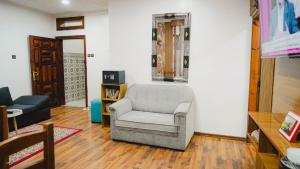 a living room with a couch and a chair at Résidence Meublée Jihane in Laayoune