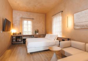 a small room with a bed and a couch at Nearchou Boutique Hotel in Chania