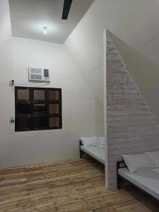 a room with two beds and a window at Campo De Laiya in San Juan
