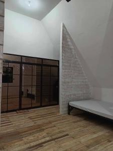 a room with a bed and a brick wall at Campo De Laiya in San Juan +11 photos