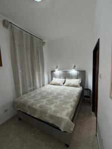 a bedroom with a large bed with a window at Old town Kotor Square in Kotor