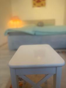 a white table with a bed in a room at Beenie 20 in Linz