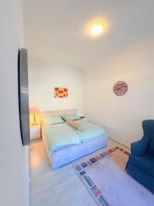 a small bedroom with a bed and a couch at Beenie 20 in Linz