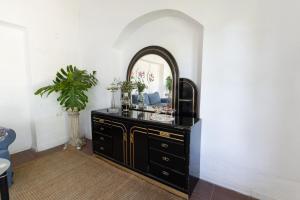 a black dresser with a mirror in a room at Casa Blue3 in Punta del Este +37 photos