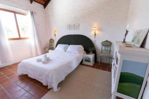 a bedroom with a large white bed in a room at Casa Blue3 in Punta del Este