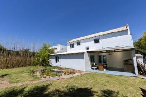 a white house with a yard in front of it at Casa Blue3 in Punta del Este
