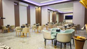 a dining room with tables and chairs in a building at نوف بلازا nouf plaza for serviced apartments in Ad Dawādimī