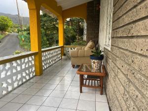 a porch with a couch and a table at Coming Home in Mount Nesbit +7 photos