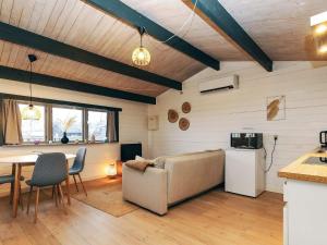 a living room with a couch and a table at 4 person holiday home in Karrebæksminde-By Traum in Karrebæksminde