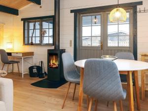 a living room with a table and a fireplace at 4 person holiday home in Karrebæksminde-By Traum in Karrebæksminde +9 photos