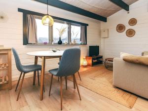 a living room with a table and chairs and a couch at 4 person holiday home in Karrebæksminde-By Traum in Karrebæksminde
