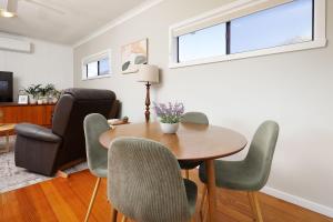 a living room with a table and chairs at Cute Cummings St Cottage in Wodonga +4 photos