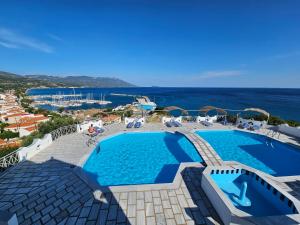 a swimming pool with a view of the ocean at Pavlis Studios Ormos in Marathokampos