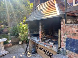 an outdoor grill in a yard with a pizza at La Nueva Vecindad in San Bernardo