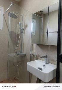 a bathroom with a sink and a shower at Serenity in Dakan