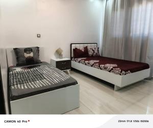 a bedroom with two beds in a room at Serenity in Dakan