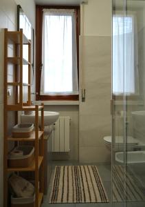 a bathroom with a sink and a toilet and a mirror at UNIque Apt Bergamo 2 in Bergamo +17 photos