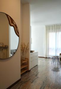a living room with a mirror and a table at UNIque Apt Bergamo 2 in Bergamo