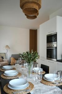 a dining room table with white plates and wine glasses at UNIque Apt Bergamo 2 in Bergamo