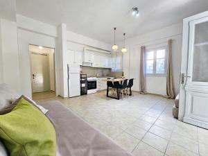 a kitchen and living room with a couch and a table at Lemon Nest in Marathokampos +10 photos