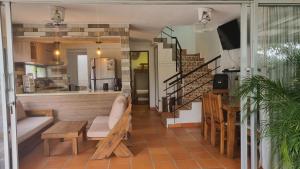 a living room with a couch and a staircase at San Jeronimo Cabaña in San Jerónimo