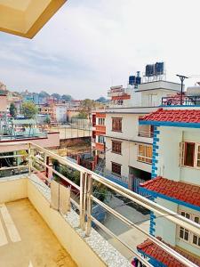 a view of a city from the balcony of a building at The Himalayan Homes in Tokna
