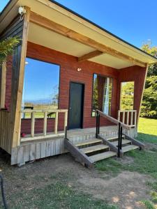 a house with a porch with a porch at Cabaña de Lujo Independiente in Frutillar