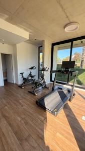 a gym with two exercise bikes and a treadmill at Sea Side2 in Piriápolis