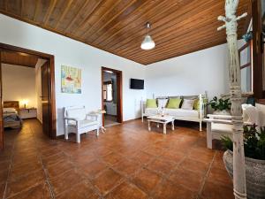 a living room with a couch and a table at Orange Nest in Marathokampos