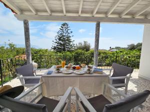 a table and chairs on a patio at Orange Nest in Marathokampos