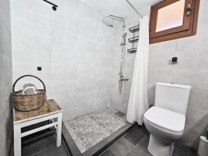 a bathroom with a toilet and a basket on a table at Orange Nest in Marathokampos +16 photos