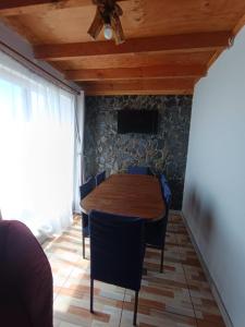 a dining room with a wooden table and chairs at Casa playa Pullay in Pullay