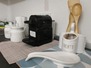 a counter with a cup of coffee and a spatula at Garibaldi Apartment Sanremo La Piazzetta in Sanremo +33 photos