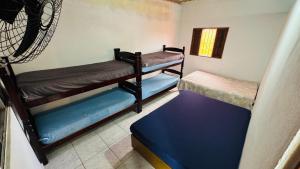 a room with three bunk beds and a window at Chácara Roteiro do Vinho com Wi-Fi in São Roque +41 photos